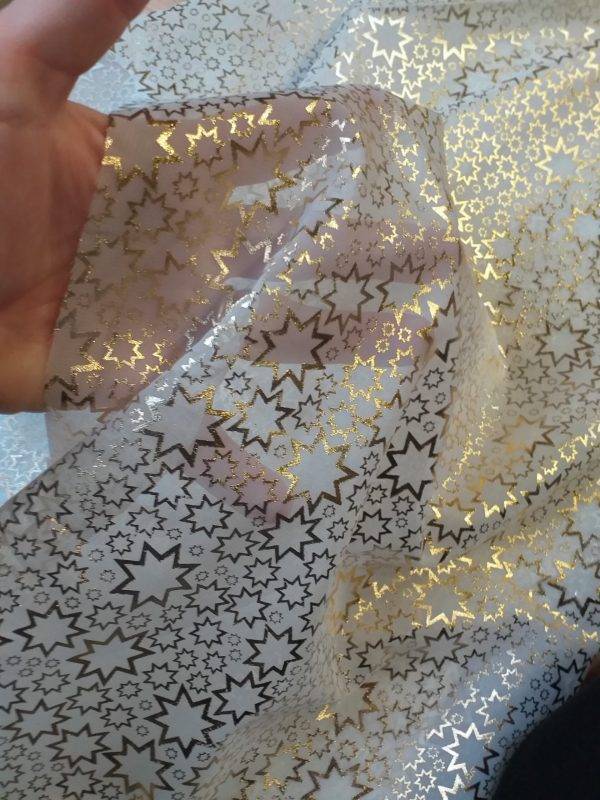 Tessuto semi-trasparente con "stelle dorate".